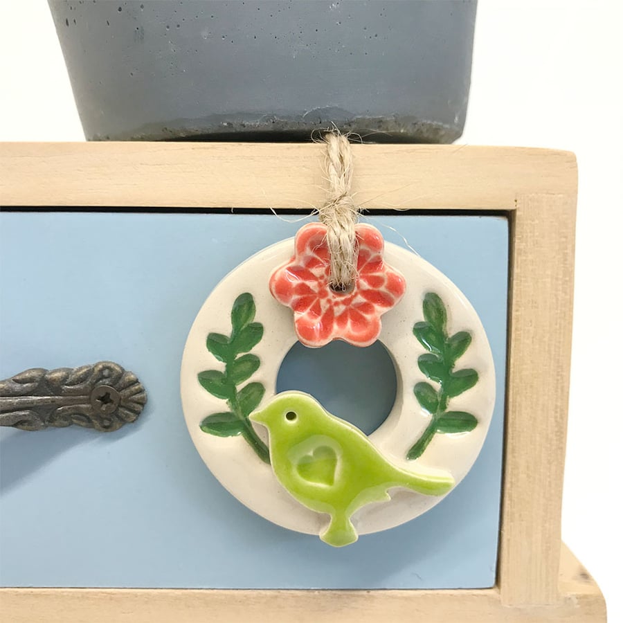 Teeny bird and flower wreath pottery decoration