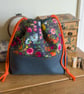 Drawstring project bag made with bright floral print in grey and orange - Image 4