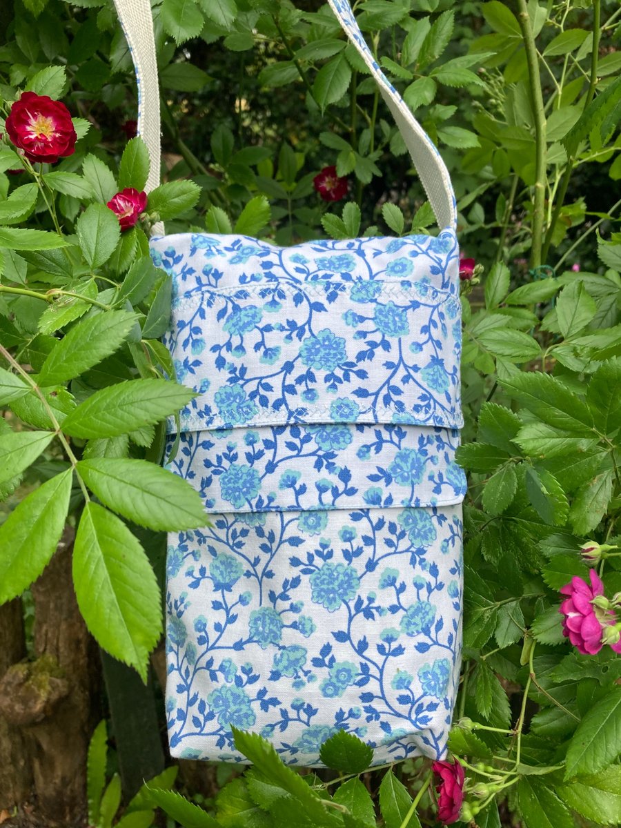 Teal blue floral crossbody bag.