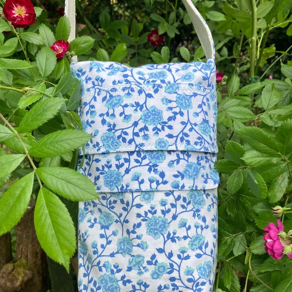 Teal blue floral crossbody bag.