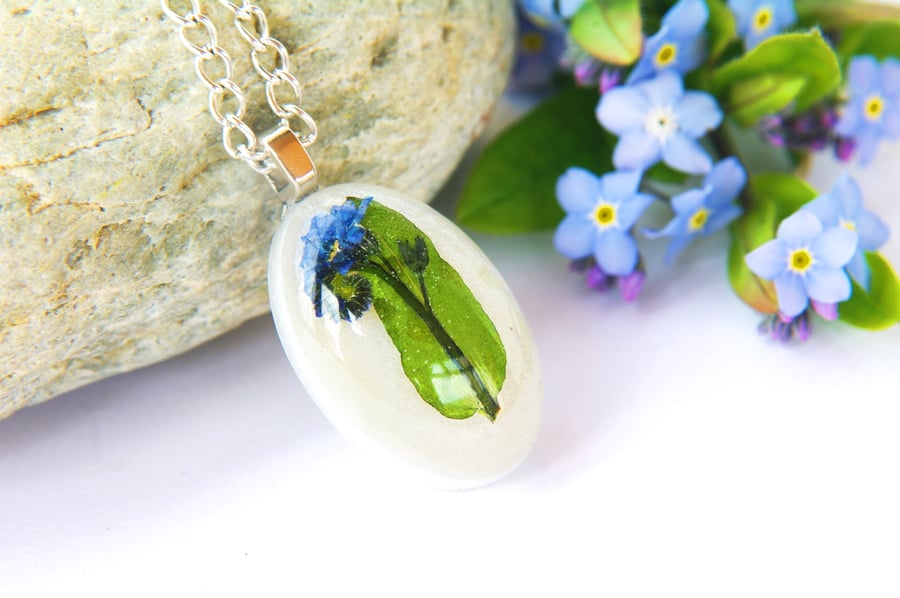 nature inspired resin necklace with real forget me not flowers