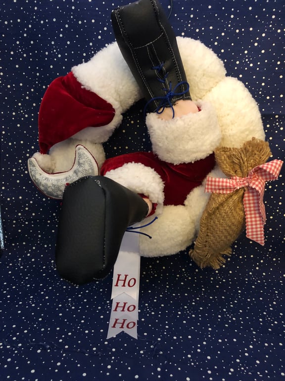 Santa’s stuck in the Christmas wreath!