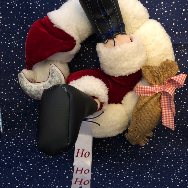 Santa’s stuck in the Christmas wreath!