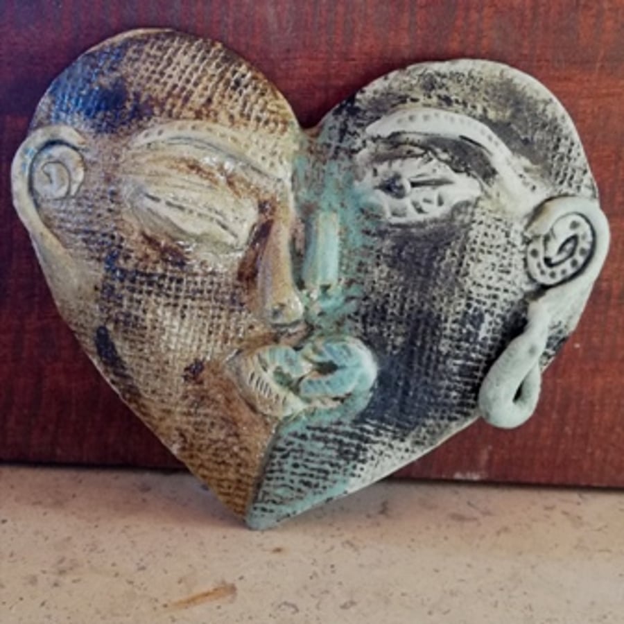 Ceramic wall decoration,heart-shaped kissing faces, sculptures