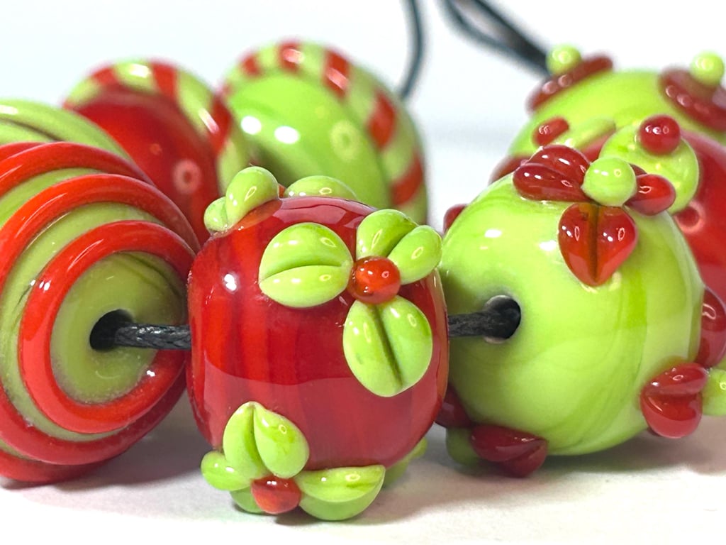 Handmade orange and green patterned lamp work glass beads