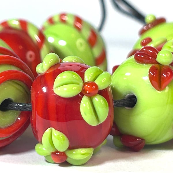 Handmade orange and green patterned lamp work glass beads