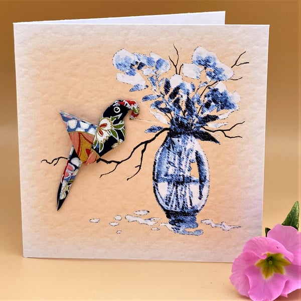 Blank Greetings Card, Hand Folded Colourful Origami Parrot on blue floral card. 