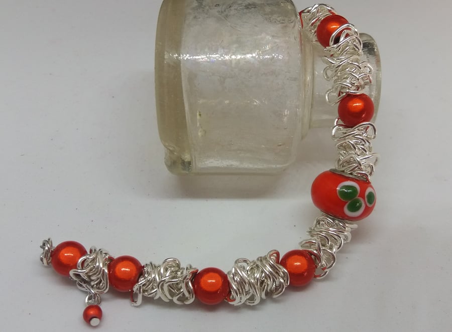 BR185 Scrunched chain bracelet with orange miracle beads.