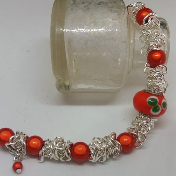 BR185 Scrunched chain bracelet with orange miracle beads.