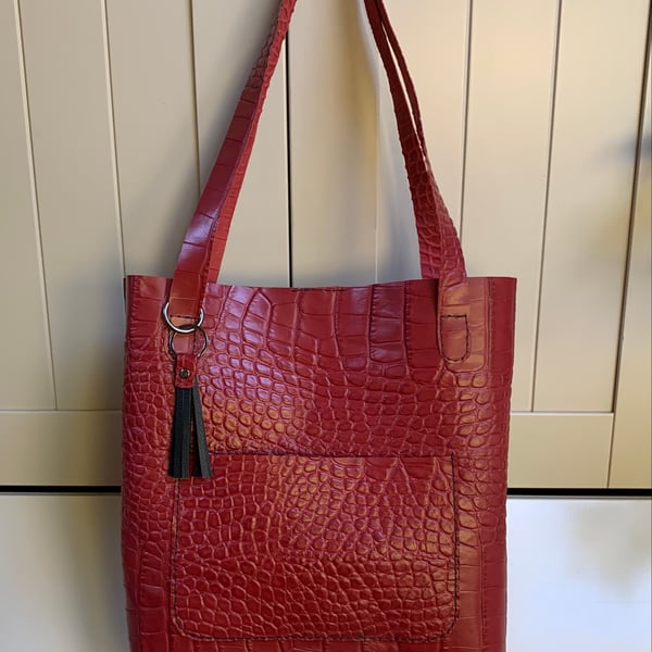 Handmade red leather tote bag versatile and stylish.