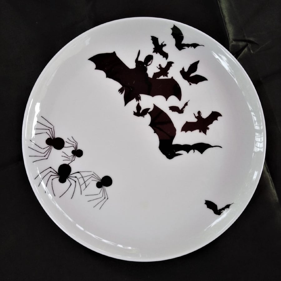 Bats and spiders on a large coup style flat bone china dinner plate.