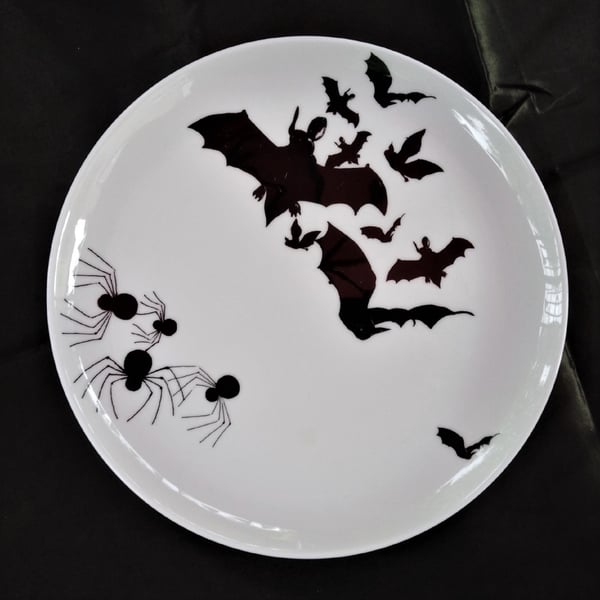 Bats and spiders on a large coup style flat bone china dinner plate.