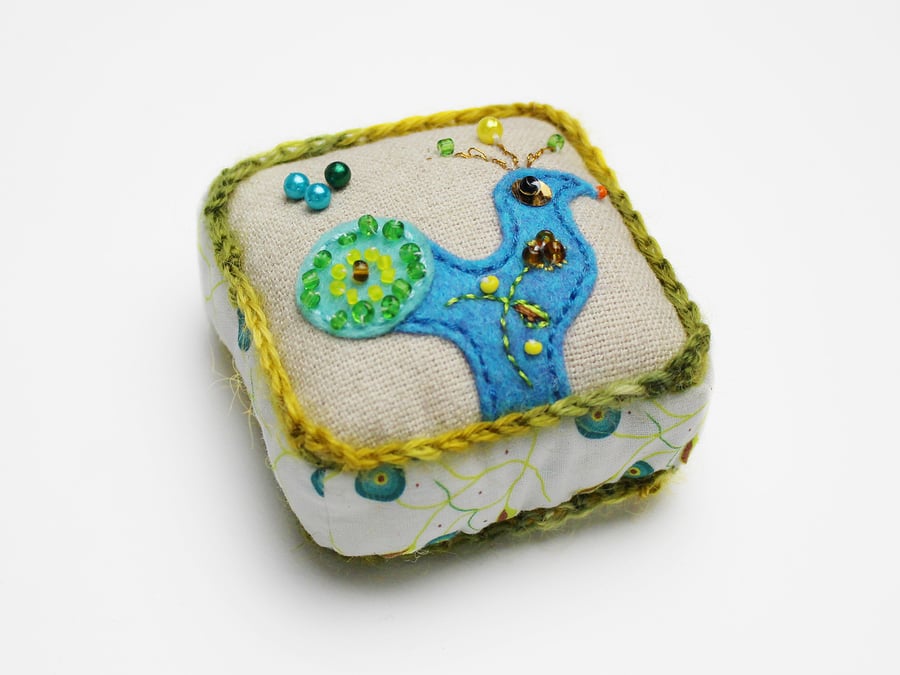 Pin cushion with turquoise appliqué peacock and Katina embroidery
