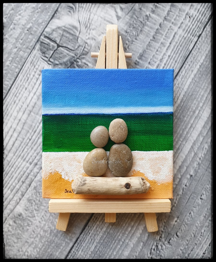 Pebble and driftwood couple by the seaside
