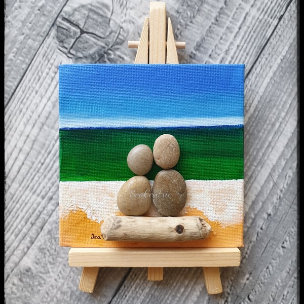 Pebble and driftwood couple by the seaside