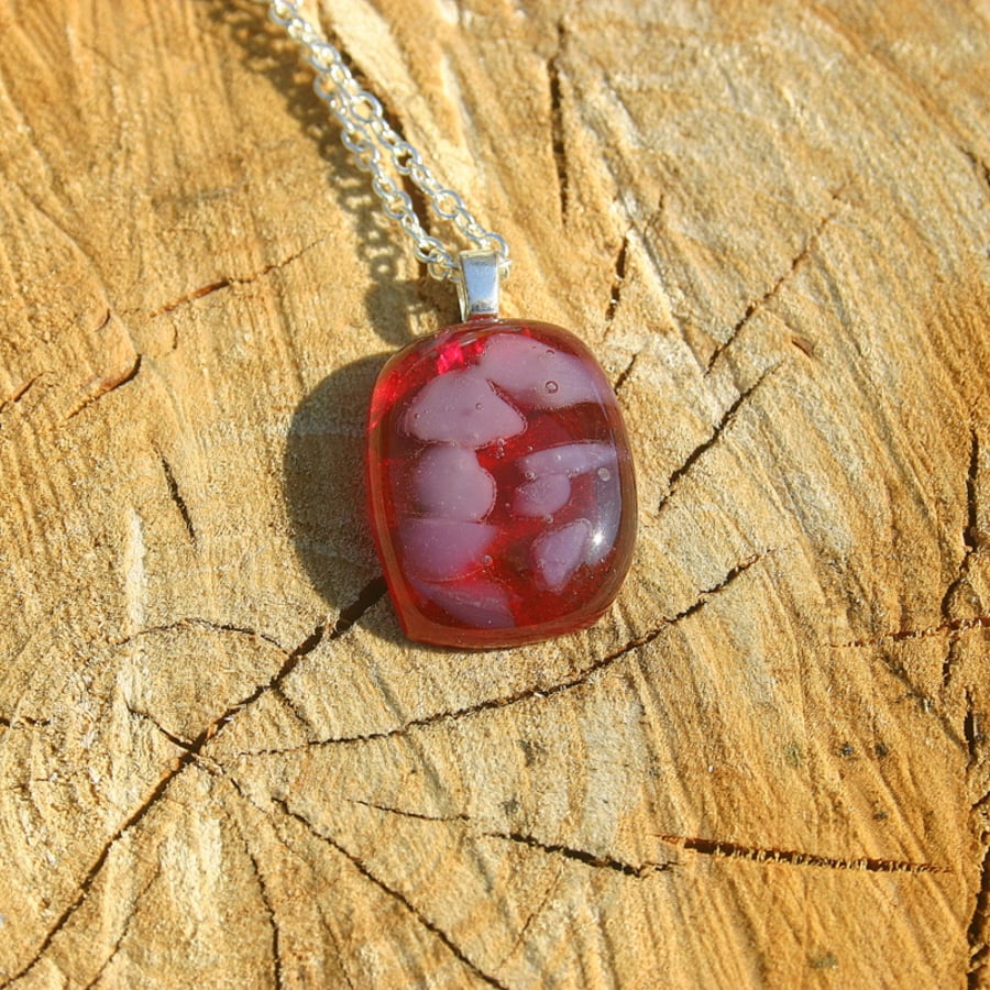 Red glass pendant on a sterling silver trace chain.