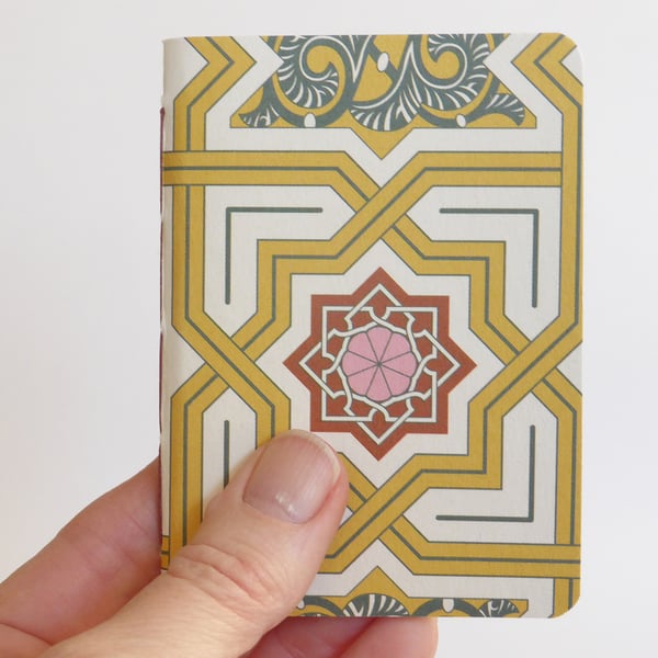 Small hand bound A7 notebook or sketchbook with yellow and red patterned cover