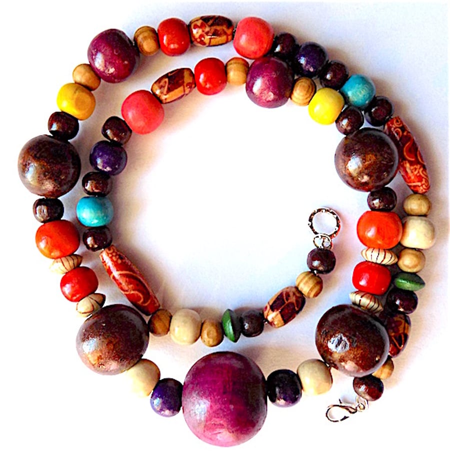 Rainbow wood bead necklace on fine chain with lobster clasp fastening.