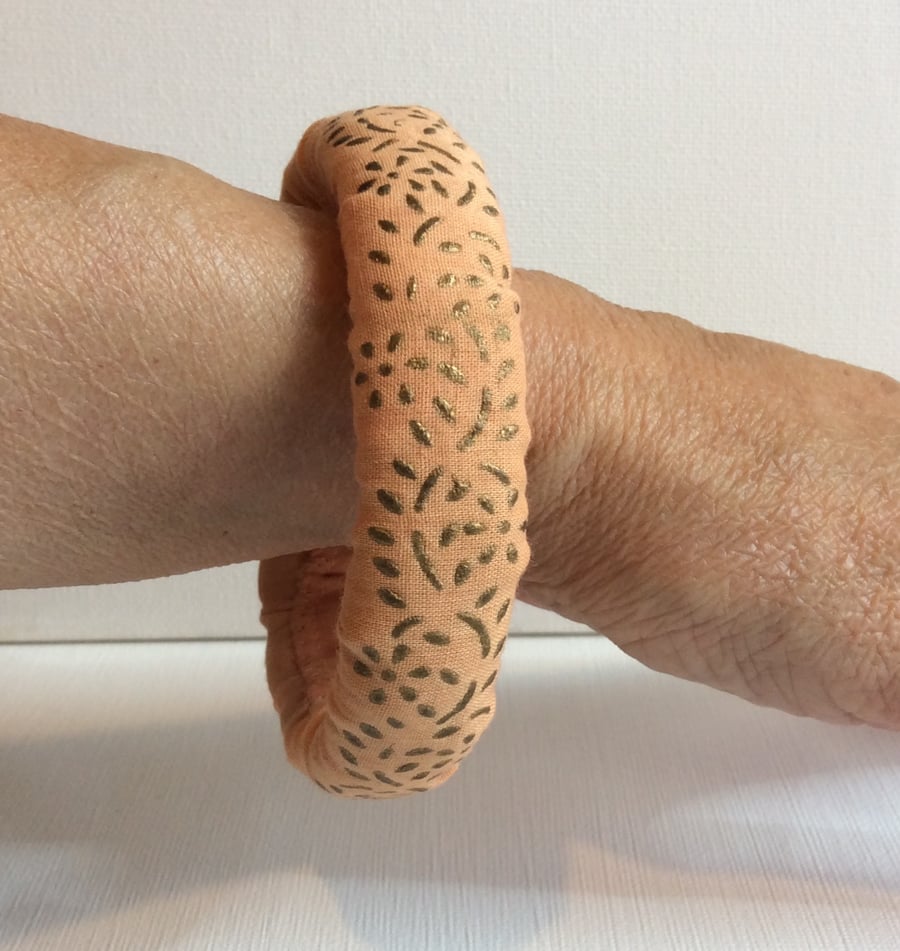 Bangle, bracelet, fabric covered, slip on, peach with gold embossed pattern