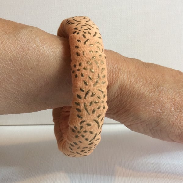Bangle, bracelet, fabric covered, slip on, peach with gold embossed pattern