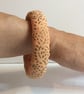 Bangle, bracelet, fabric covered, slip on, peach with gold embossed pattern - Image 1