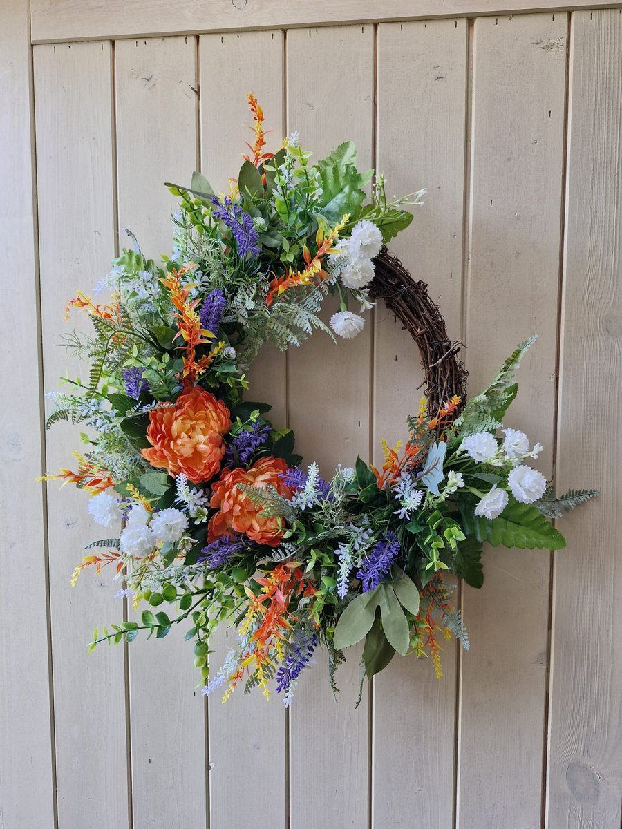 Flo. Half covered wreath. Door,table, grave  wall.