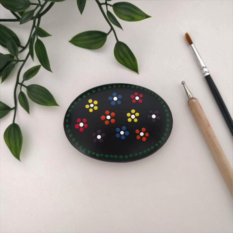 Flower dot painted wooden pebble