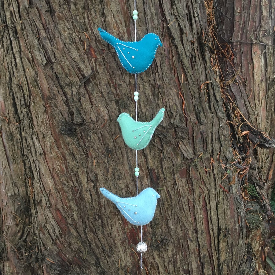 Hanging bird garland in blues and greens