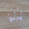 Rose quartz earrings in sterling silver. Thin hoops with pink gemstones.