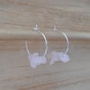 Rose quartz earrings in sterling silver. Thin hoops with pink gemstones.