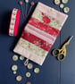 Patchwork stripe needle case made from Tilda fabric in shades of red and pink - Image 6