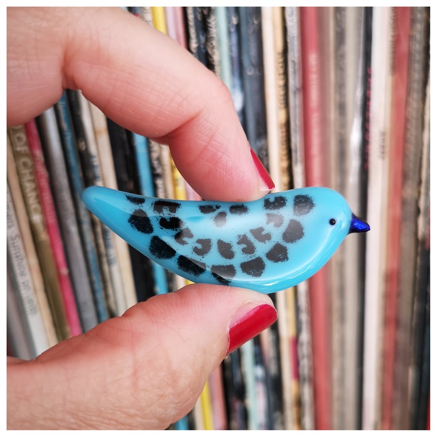 bird brooch with dark blue beak