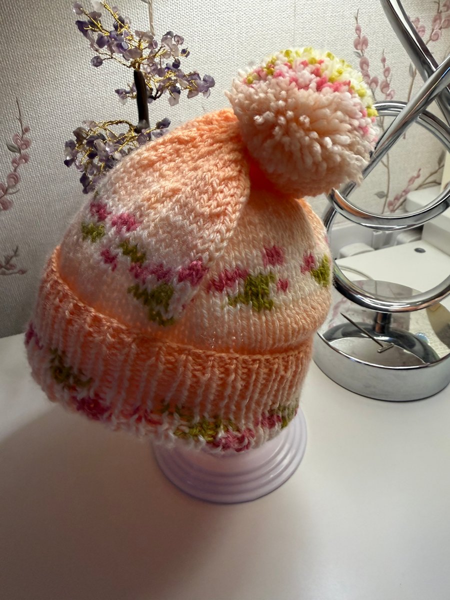 Knitted baby hat with rib and Pom Pom.