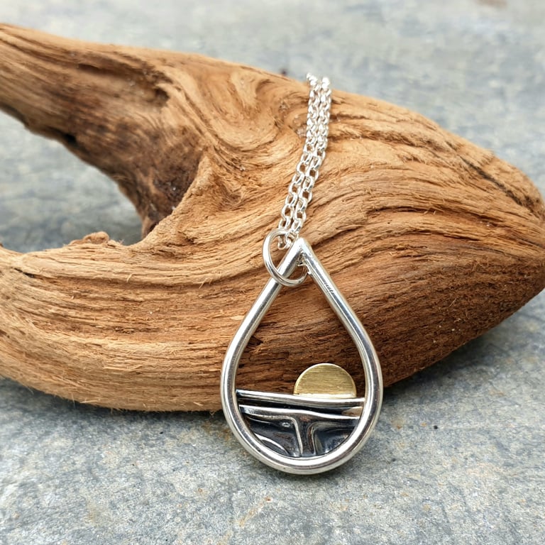 Silver teardrop sun rising over the sea pendant