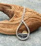 Silver teardrop sun rising over the sea pendant