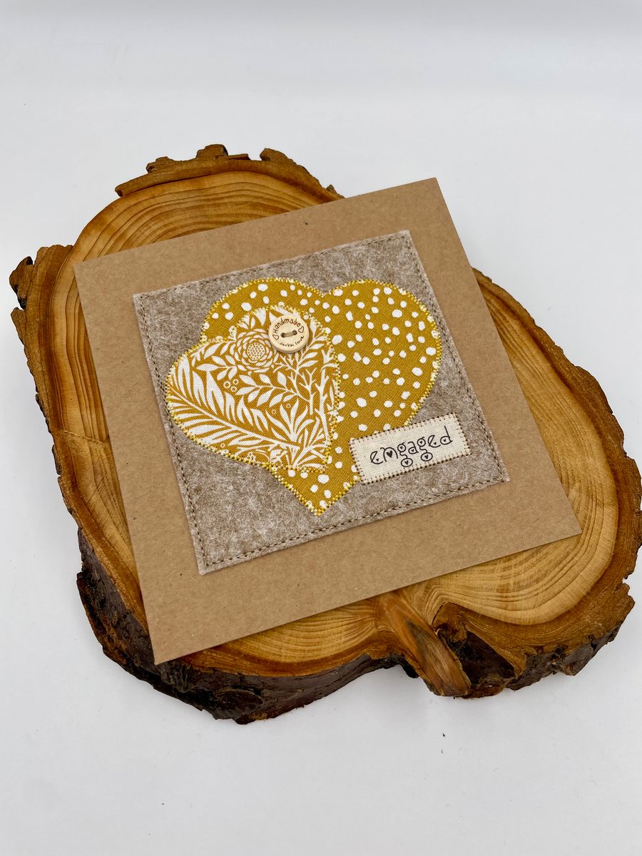 Appliqué engagement card with two interlocked hearts