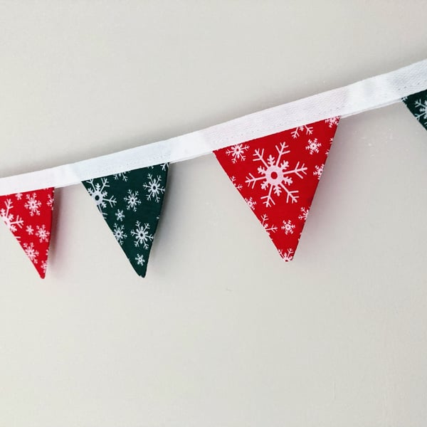 Red and green Christmas double sided fabric mini bunting with white snowflakes. 