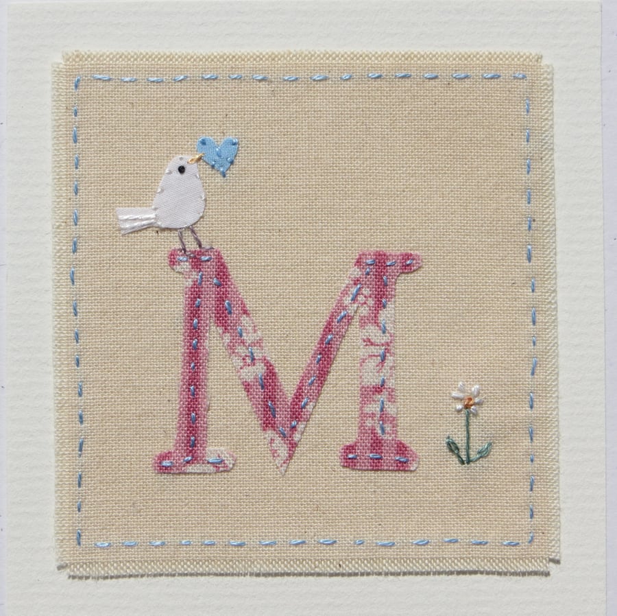 Hand-stitched letter M card with dove, heart and daisy flower