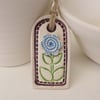Small ceramic gift tag decoration with flower