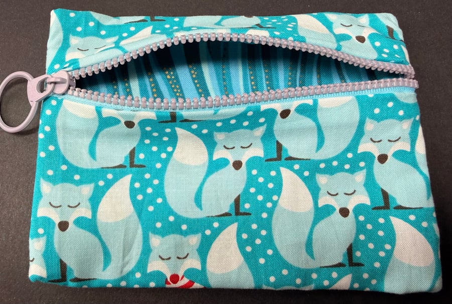 Small funky zipped pouch with charming foxes on light turquoise