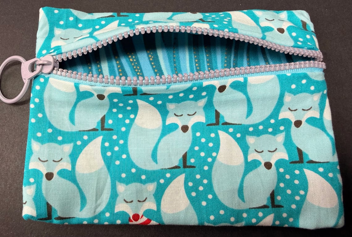 Small funky zipped pouch with charming foxes on light turquoise