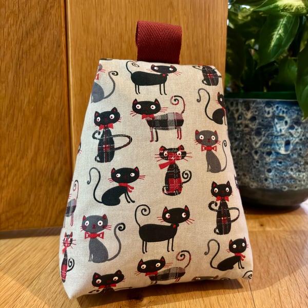 Cotton fabric doorstop in fun tartan cat print, filled with pebbles.
