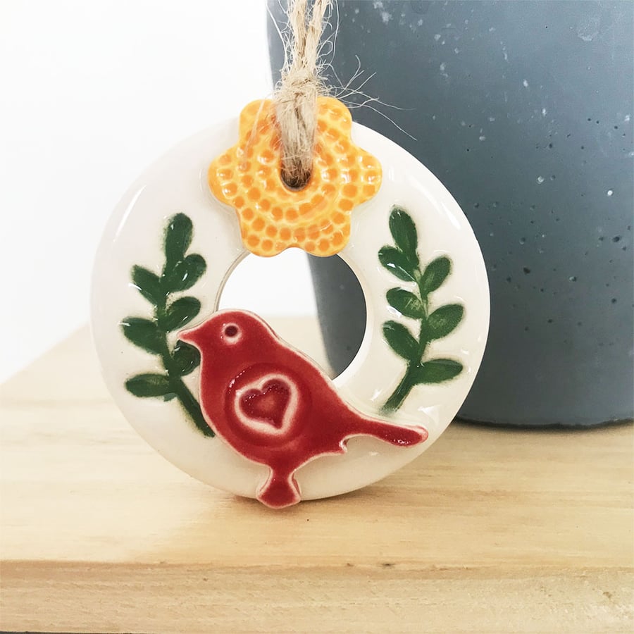 Teeny bird and flower wreath pottery decoration