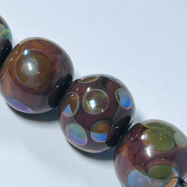 Handmade brown and iridescent patterned lamp work glass beads