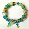 Sea inspired sparkly memory wire paper beaded green, yellow and blue bracelet 