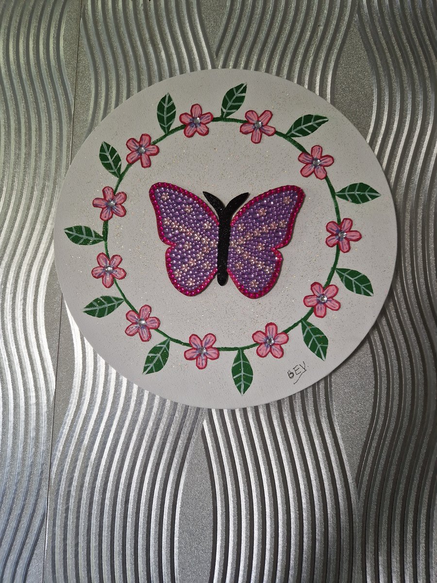Sequinned butterfly with flower border. 