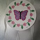 Sequinned butterfly with flower border. 