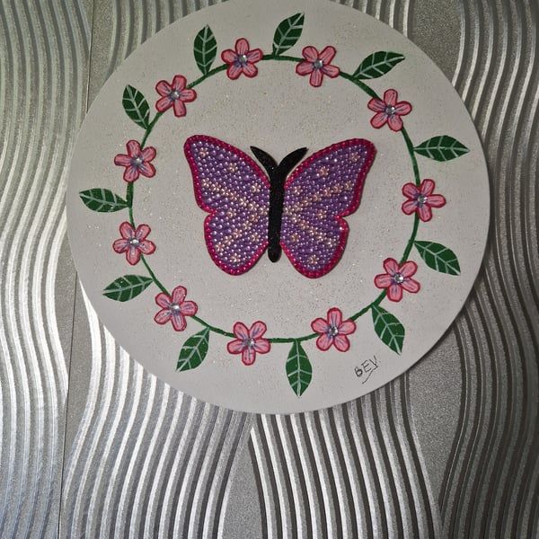 Sequinned butterfly with flower border. 