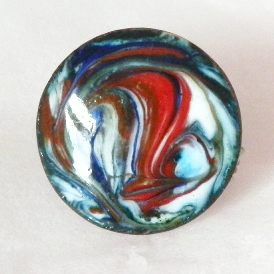 small round brooch - scrolled red and blue over white