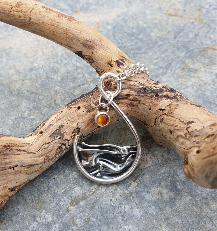 Silver and amber sun rising over sea pendant